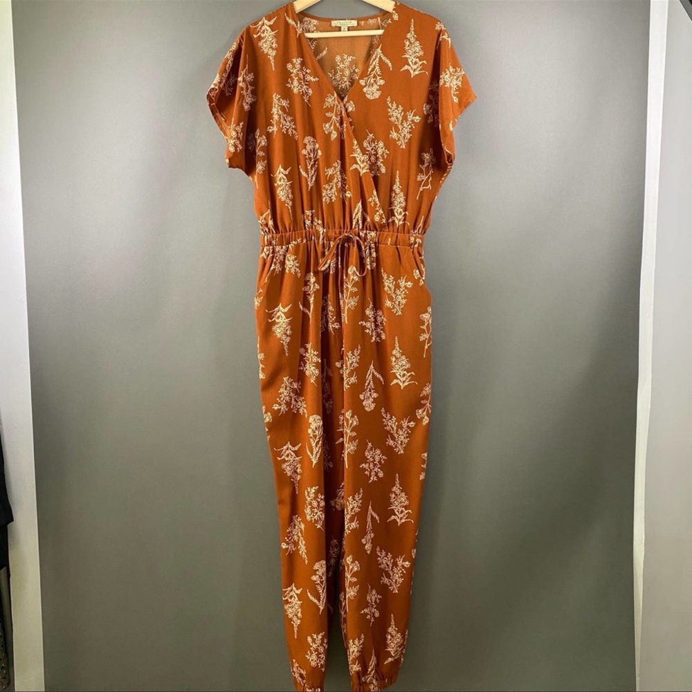 Short sleeve, rust/terracotta floral jumpsuit.